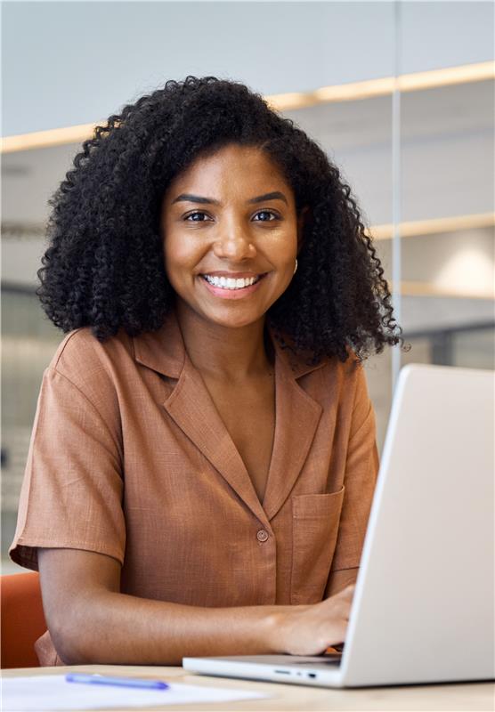 Person using laptop with email icons
